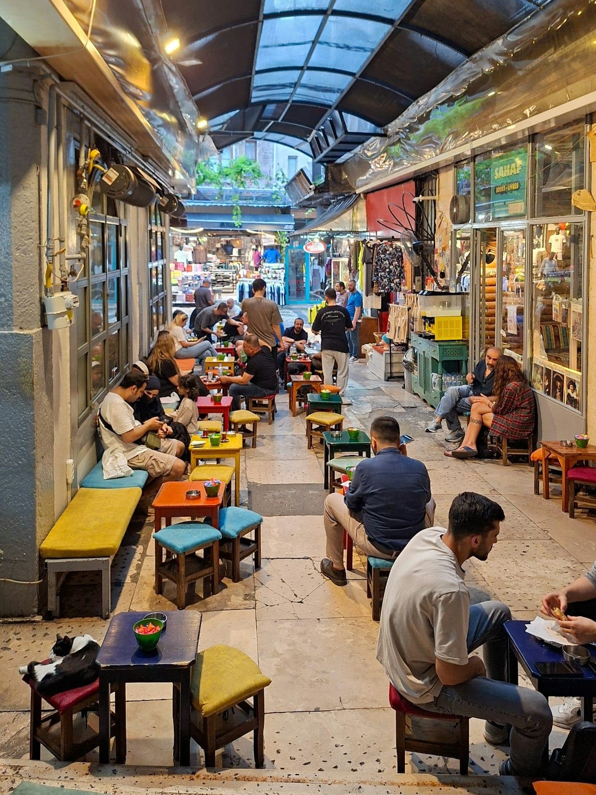 An alley lined with low stools and small tables