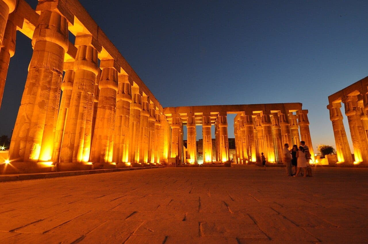 The columns of Luxor Temple, floodlit gold against the night sky.