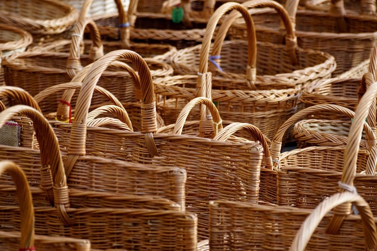 Hand-woven baskets with their handles, stacked one against another.