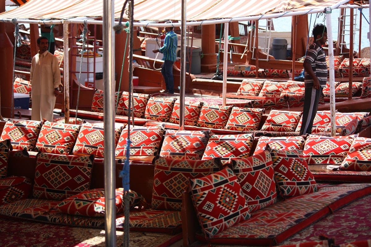 Red kilim benches lined up under an awning