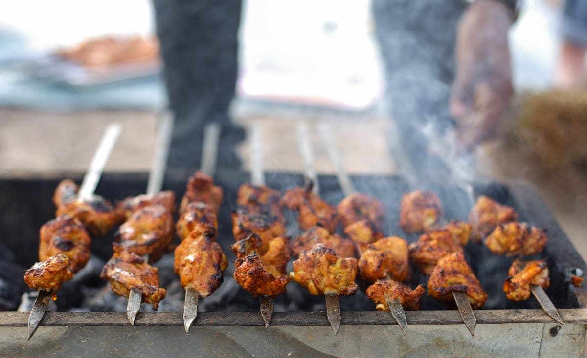 Skewers over the coals, in the smoke