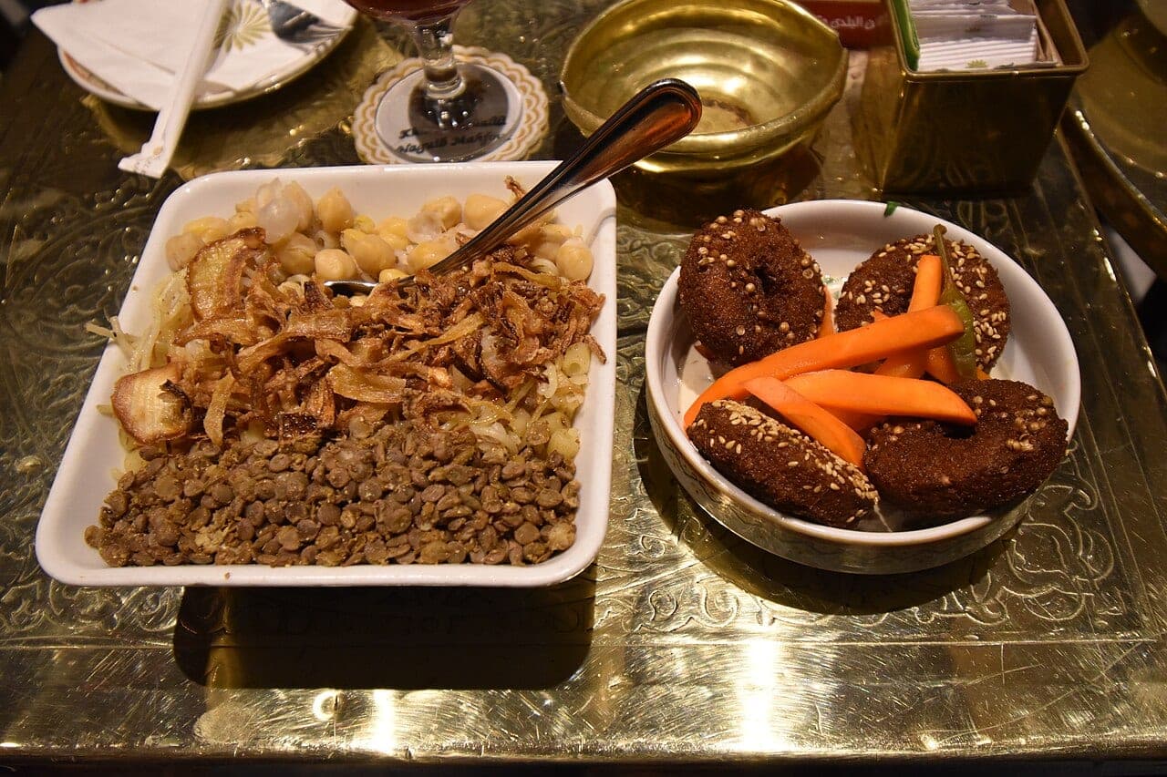 A koshari and sesame taameya on an engraved brass tray.