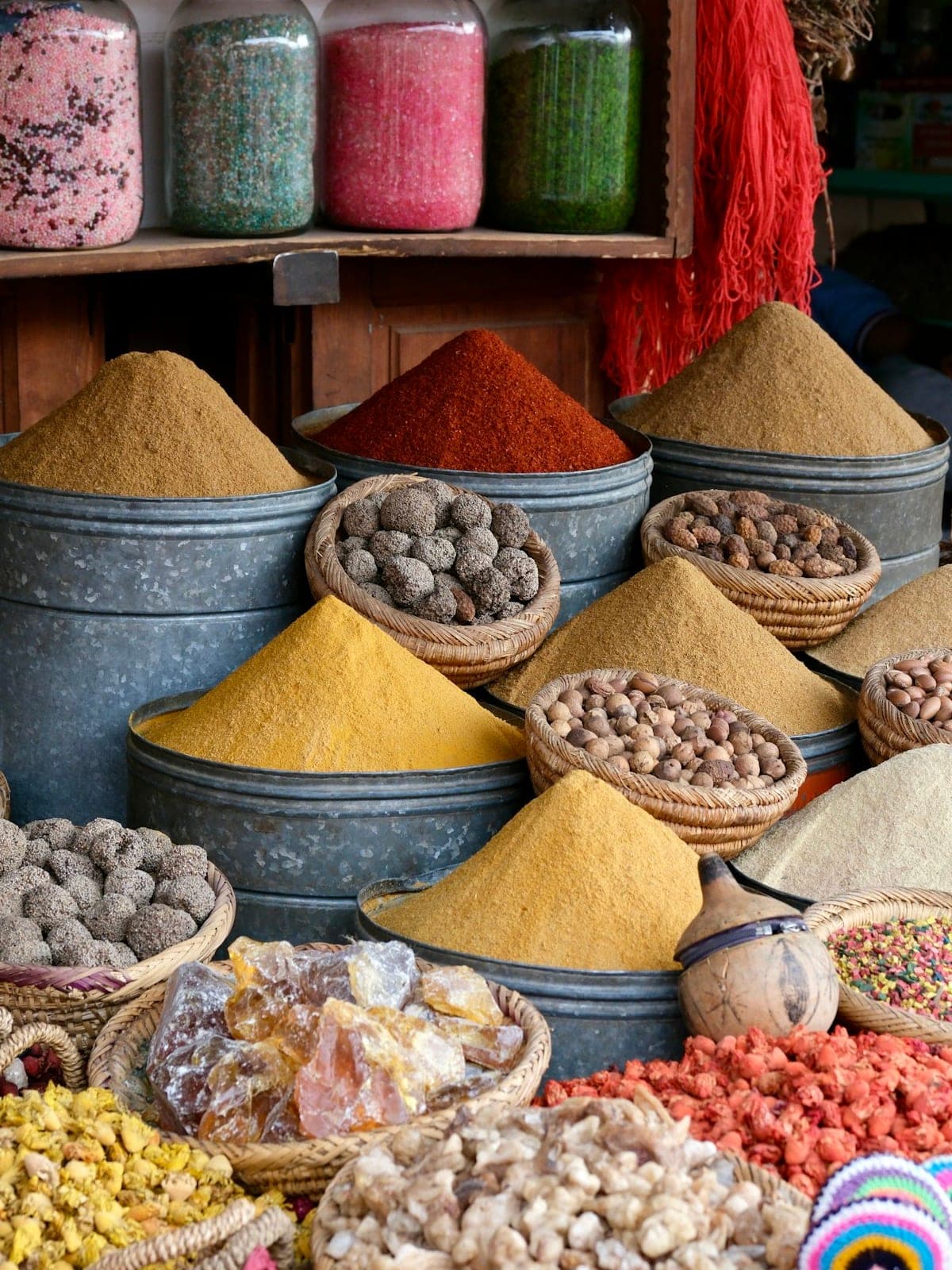Cones of spices in their basins, and baskets of seeds
