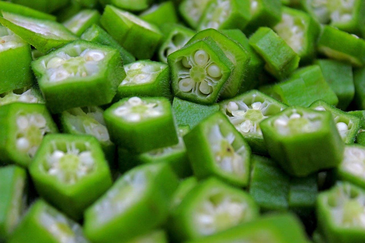 Fresh okra sliced into rounds, in close-up.
