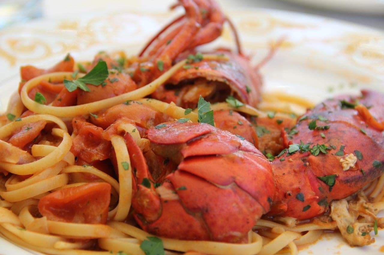 Long pasta with lobster in tomato sauce.