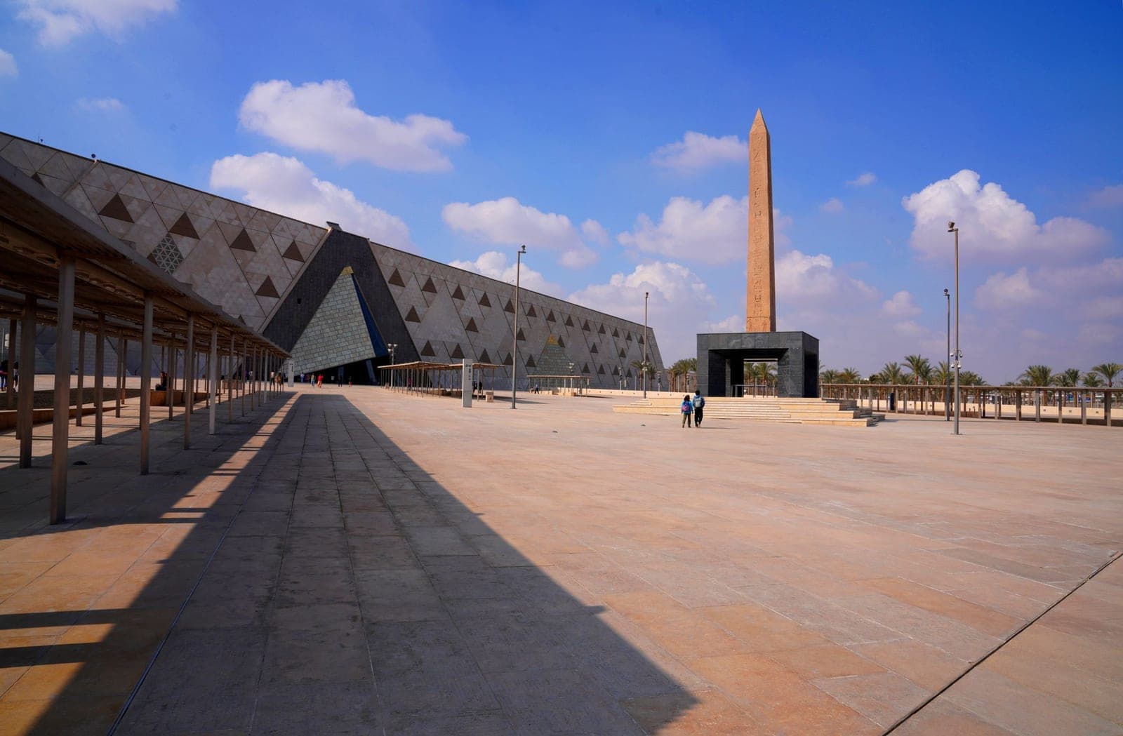The forecourt and the hanging obelisk, before the museum's triangulated façade.