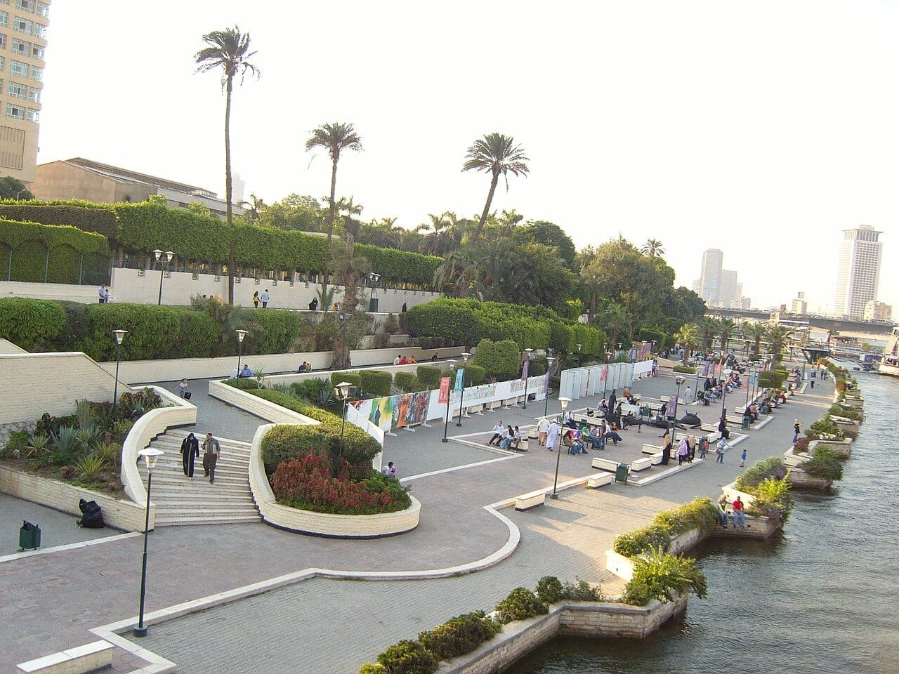 The garden's terraces stepping down to the Nile, with their palms and hedges, seen from the bridge.