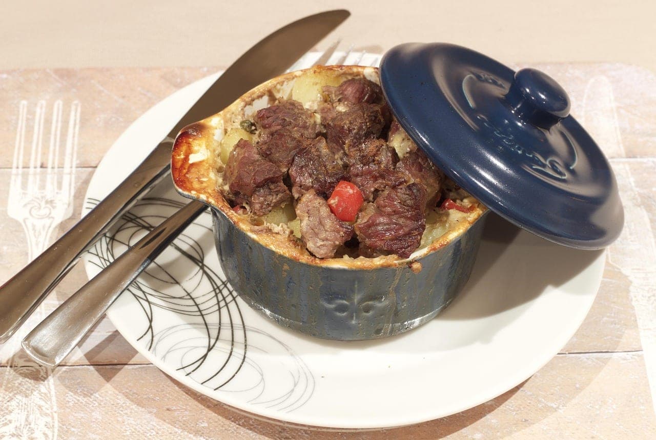 A beef and potato stew served in its small casserole dish.