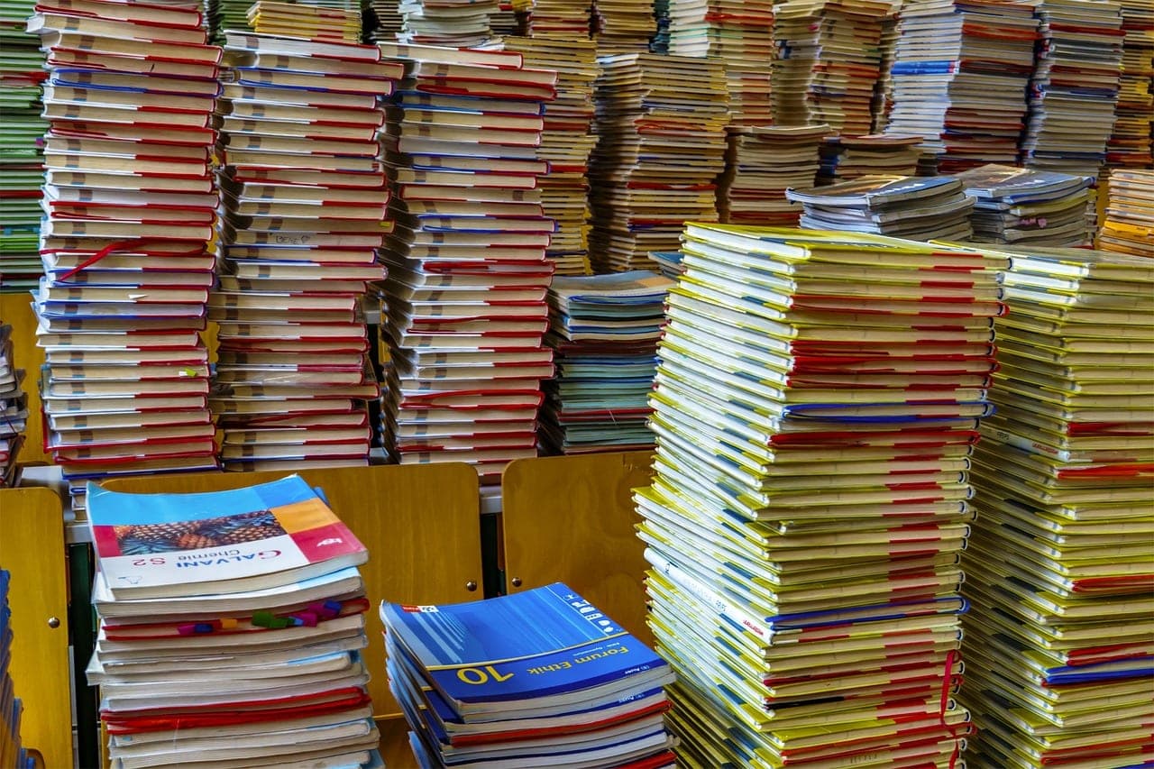 Stacks of second-hand books and textbooks piled to the top, packed tight against one another.