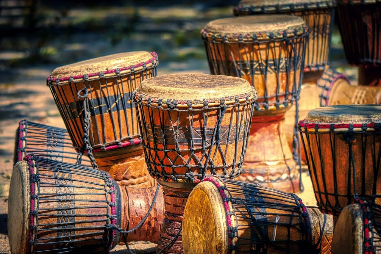 Wooden skin drums set down in the evening light.