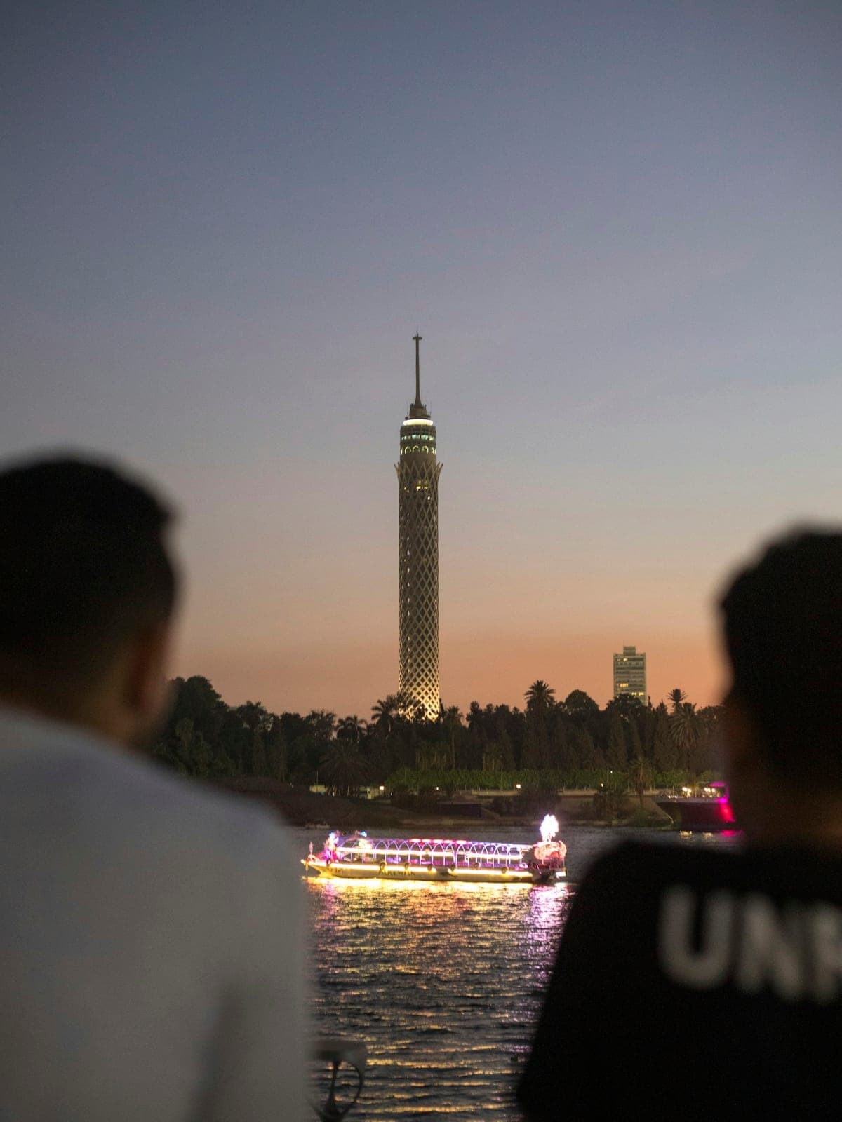 The Nile at dusk, the Cairo Tower and a lit-up boat