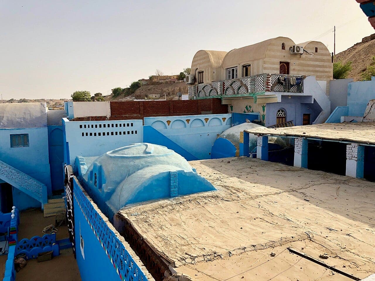 Ochre vaulted houses and blue-painted terraces backing onto the hillside.