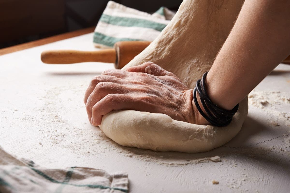 Dough worked by hand, rolling pin and flour