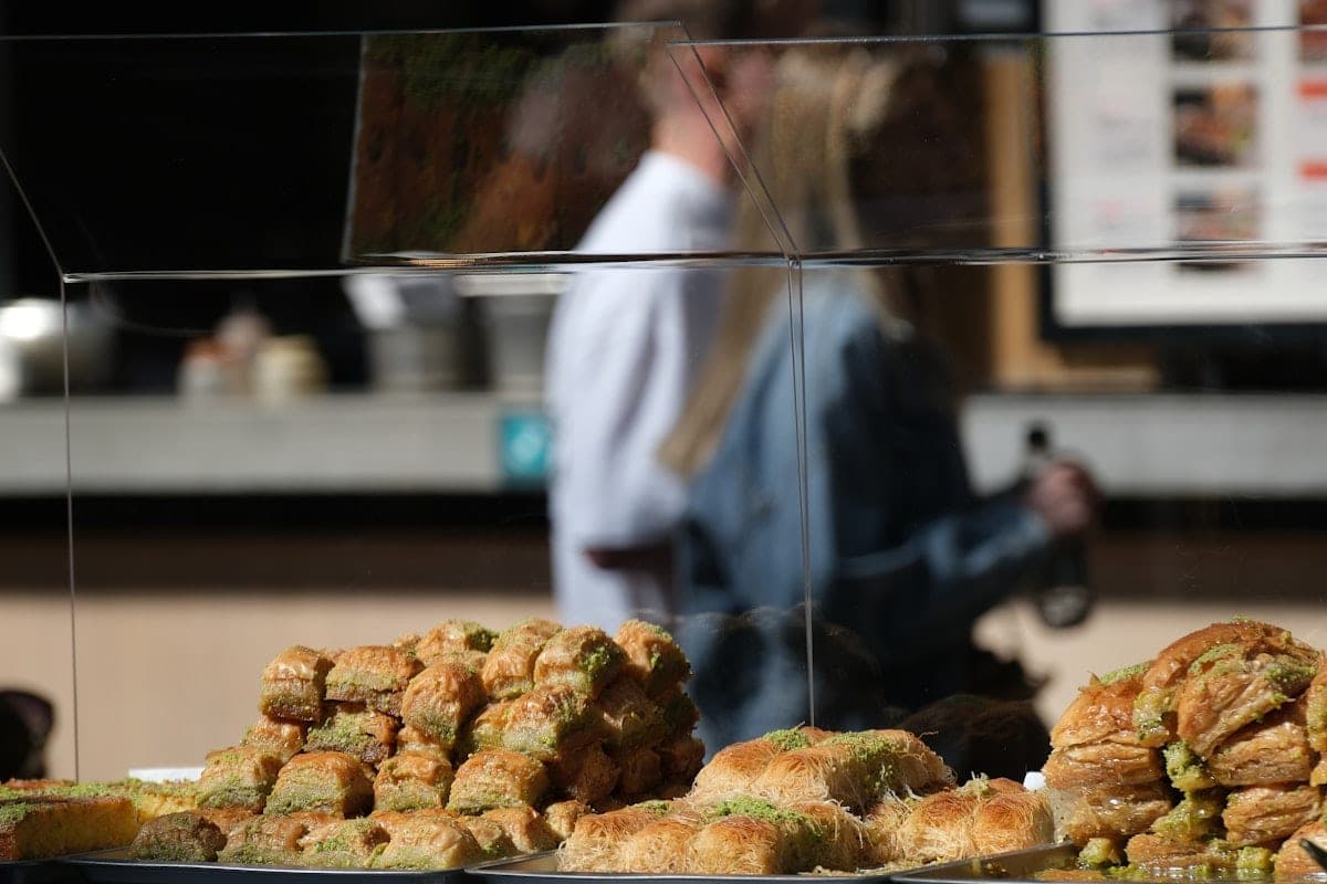 A tray of syrup pastries behind the display glass