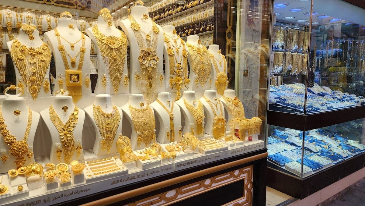 Gold sets lined up on their busts, in the window