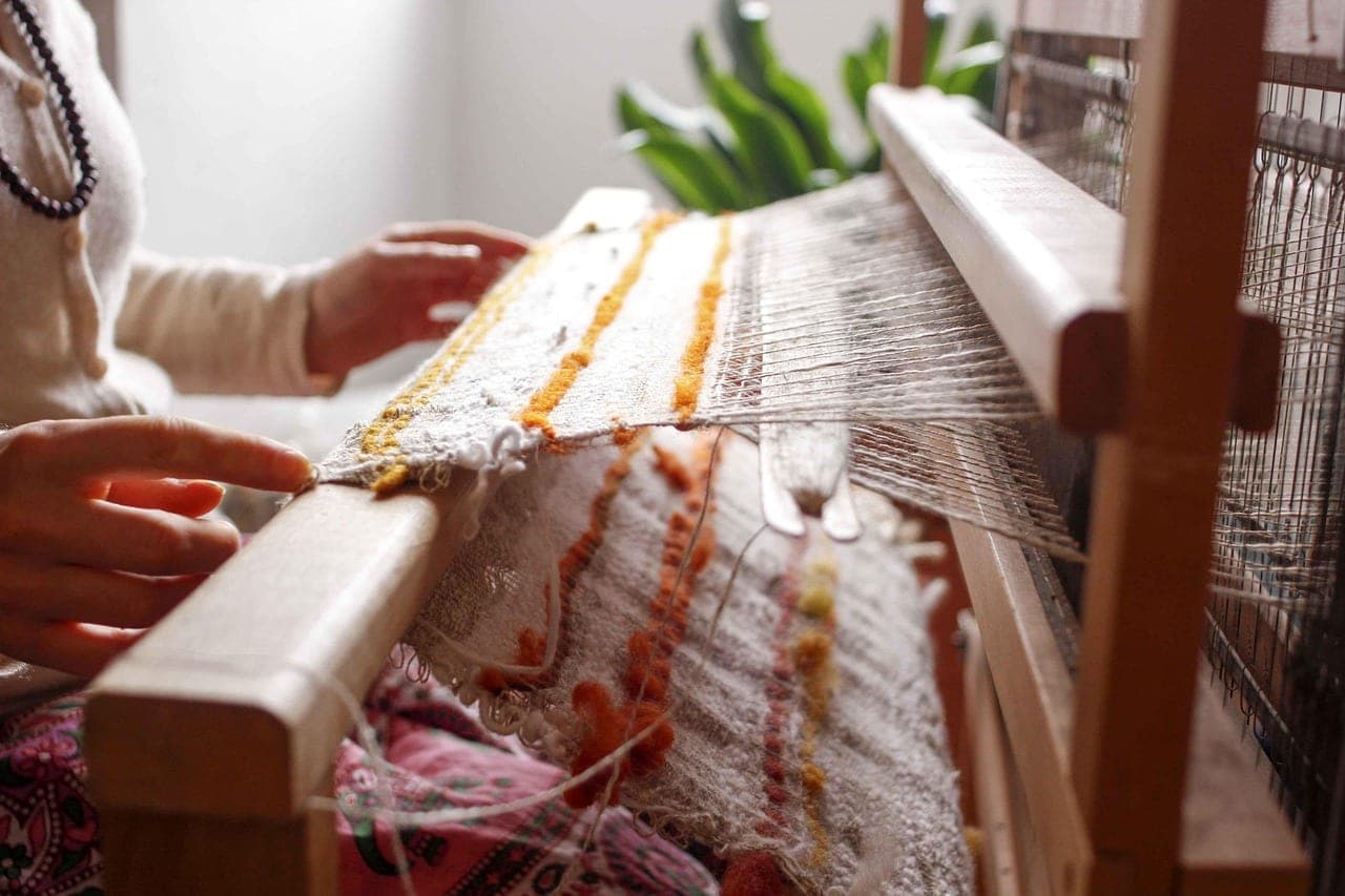 Coloured wool woven by hand on a wooden loom.