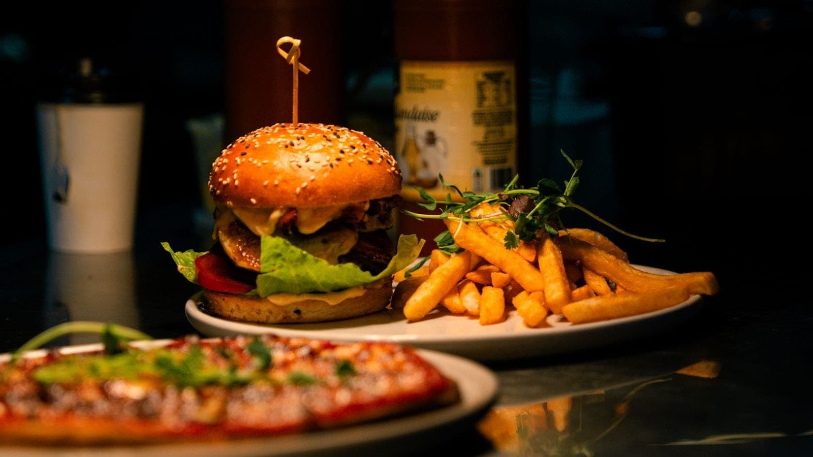 A burger and a pizza — the kind of menu, not the house