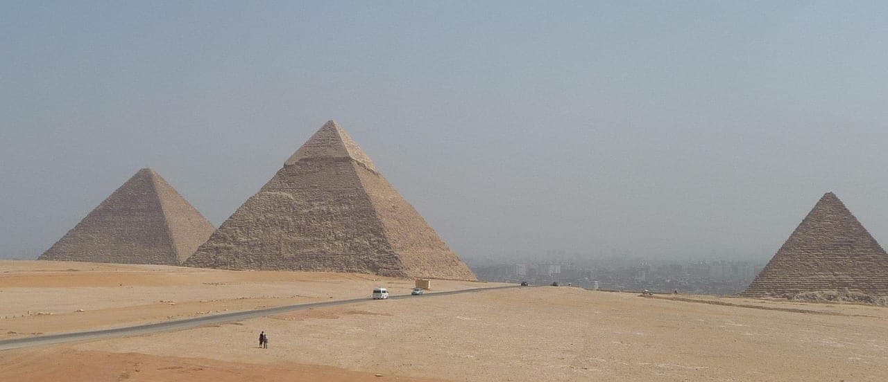 The three pyramids — and Cairo running right up to the plateau.