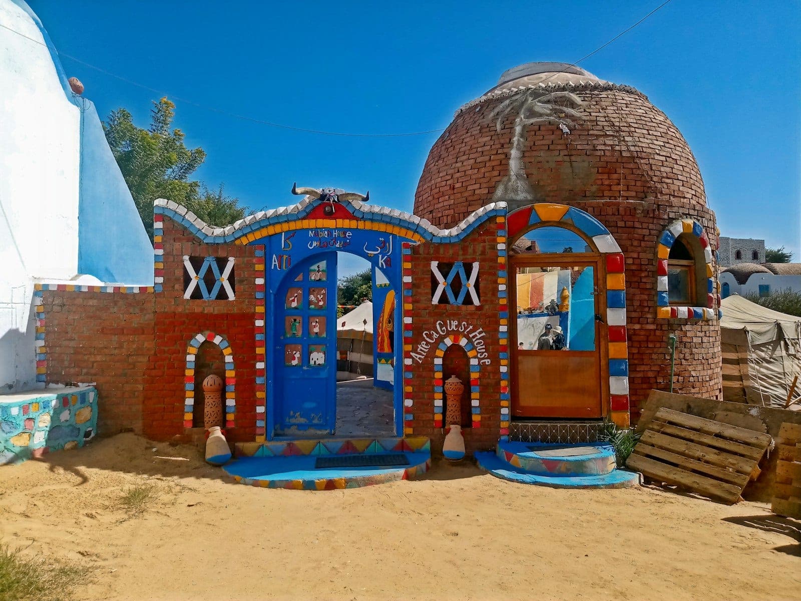A Nubian house: brick dome and painted façade.