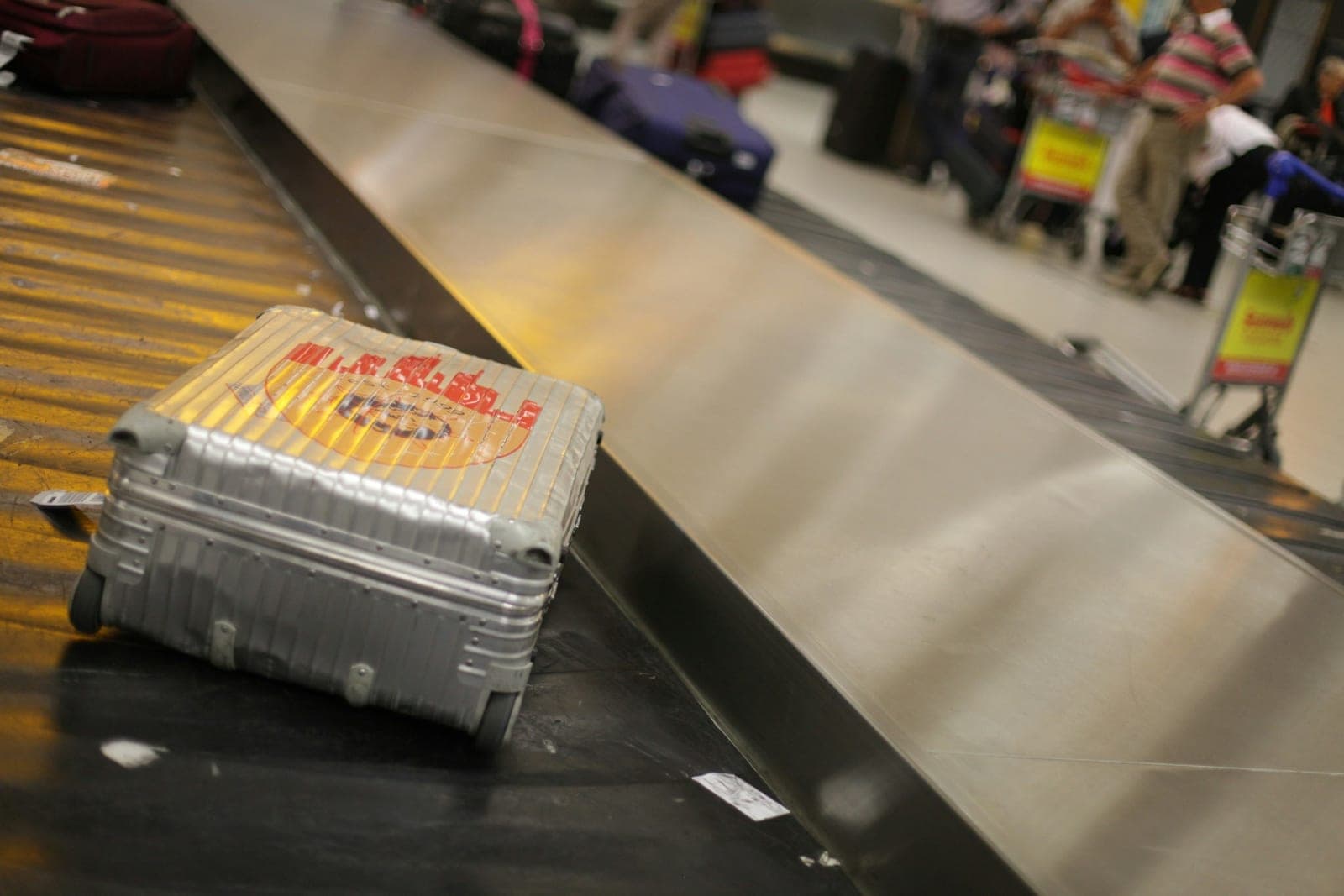 A suitcase on the baggage belt on arrival.